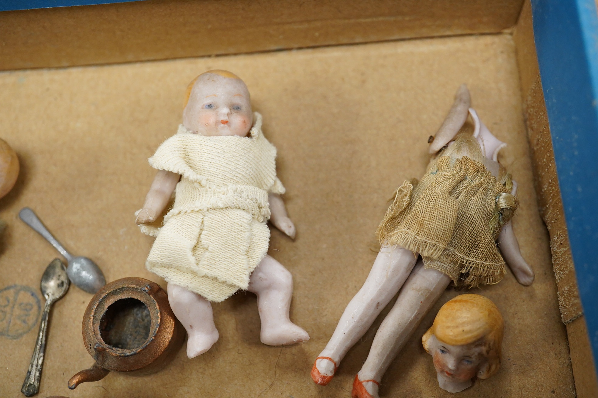 Eight early 20th century ceramic ‘doll's house’ dolls, approx 8cm long, with articulated limbs, together with a small quantity of doll house items by Pit-A-Pat series, etc. Condition - poor to fair.